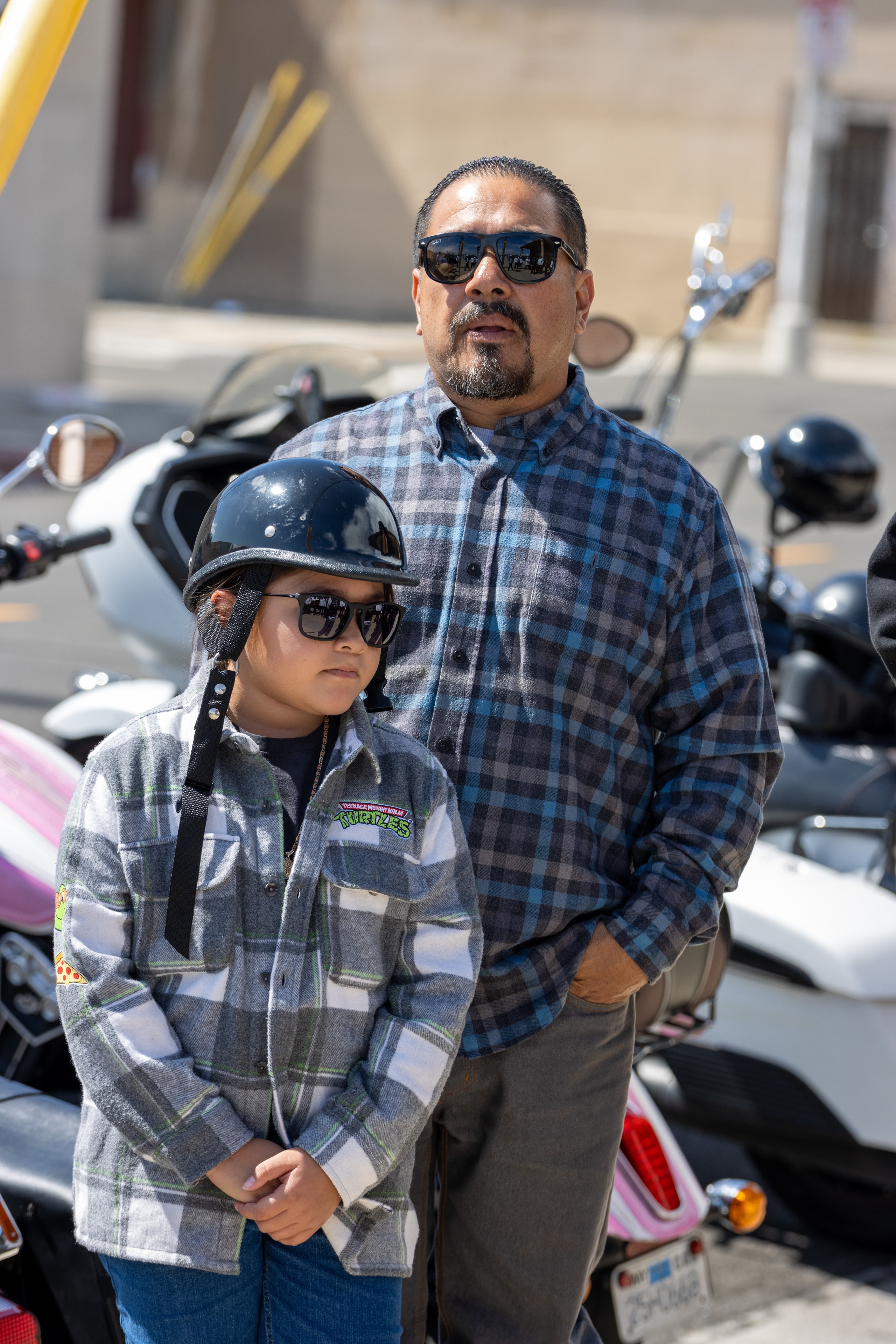 Club member and child wearing motorcycle helmets